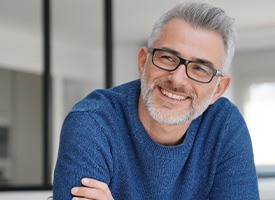 man smiling with arms crossed 