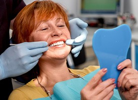 woman smiling while visiting dentist