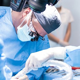 an oral surgeon performing dental implant surgery