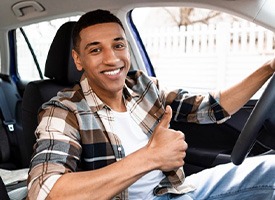 Man smiles in car