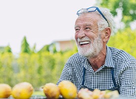 Man smiles outdoors