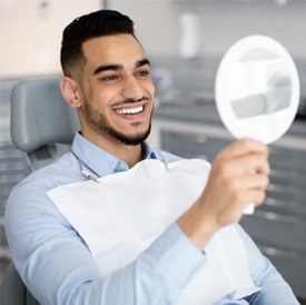 Patient smiling at reflection in mirror